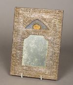 An antique Qajar unmarked pressed silver framed mirror Of ornate floral design,