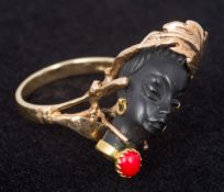 A 14K gold ring Set with the bust of a woman wearing a coral cabochon pendant,