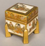 A 19th century Japanese Satsuma box and cover Of square section form, with gilt heightened legs,