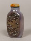 A Chinese agate snuff bottle Carved to one side with two fish. 6.25 cm high.