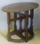 A 17th century style oak side table The oval top above the block and turned legs united with