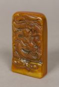 A Chinese carved soapstone seal Of tablet form, decorated with a figure riding a dragon,