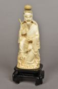 A late 19th/early 20th century Chinese carved ivory figure Worked as a fisherman holding his catch,