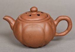 A Chinese Yixing pottery teapot Modelled as a fruit, the cover reticulated. 11 cm high.