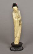 A late 19th/early 20th century Chinese carved ivory figure of Guanyin Standing on an ebonised