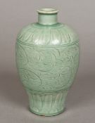 A Chinese porcelain vase With incised decoration and allover celadon glaze. 21 cm high.