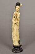 A late 19th/early 20th century Chinese carved ivory figure of Guanyin Holding a lotus flower,