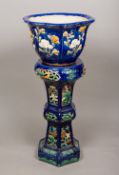A Chinese pottery jardiniere on stand The blue glazed ground decorated with floral sprays,