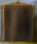 A Victorian gilt framed over mantel mirror The crested top above the bead work frame,