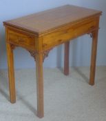 A Colonial style card table The revolving hinged rectangular top above a plain frieze incorporating