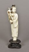 A late 19th/early 20th century Chinese carved ivory figure of a woman holding a fruiting bough On