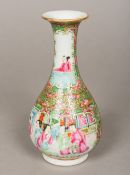A small 19th century Canton famille rose bottle vase Typically decorated with figural and bird