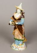 A 19th century Continental majolica figure of a musician Modelled in the chinoiserie style. 32.