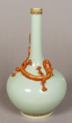 A Chinese porcelain vase The celadon glazed body with applied red and gilt dragon,