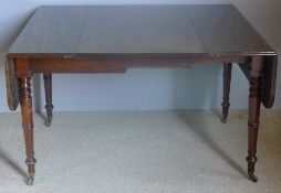 An early 19th century mahogany drop-flap extending dining table The hinged rounded rectangular top