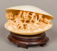 A late 19th/early 20th century carved ivory clam The well carved interior intricately worked with