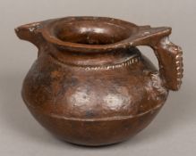 An antiquity type pottery ewer Of squat baluster form with loop handle, with allover brown glaze.