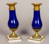 A pair of 19th century Continental gilt bronze mounted blue glass vases Each of flared bulbous form,