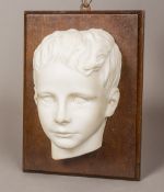 A Victorian carved marble bust Modelled as a young boy,