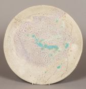 A Studio pottery raku type glazed dish With turquoise splashes, unsigned. 41 cm diameter.