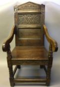 An 18th century oak Wainscott chair The carved panelled back above the scrolling open arms and