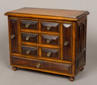 A 19th century Continental oak and walnut table top chest of drawers The moulded rectangular top