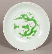 A Chinese porcelain dished plate Decorated with green dragons,