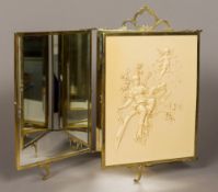 A Continental brass mounted ivorine panelled triptych dressing mirror Worked with a musical muse