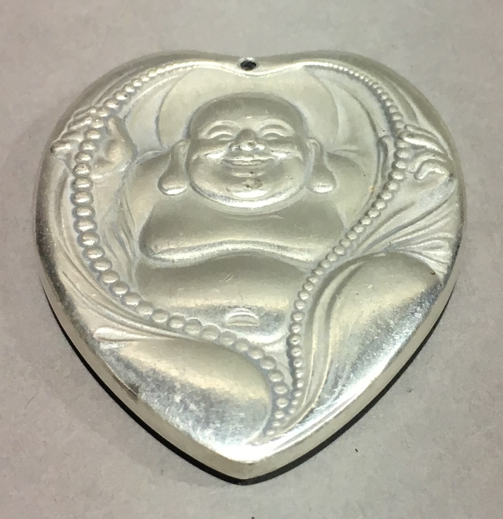 A pendant in the form of Buddha