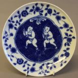 A Chinese blue and white porcelain plate Decorated with two boys within an arabesque and floral