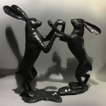 A pair of bronze boxing hares