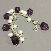 A silver and amethyst bracelet