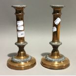 A pair of copper candlesticks