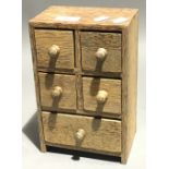 A Partridge wood miniature bank of drawers