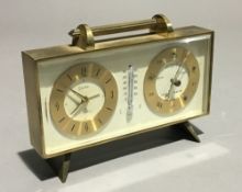 A brass cased clock and barometer