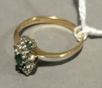 A 9 ct gold emerald and white stone set ring