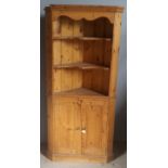 A modern pine corner cupboard