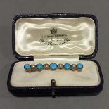 A turquoise and seed pearl bar brooch