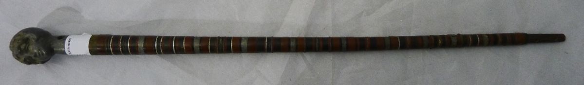 A small stick with female bust handle