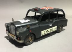 A tin toy London taxi cab