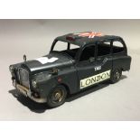 A tin toy London taxi cab