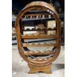 A tulip wood wine rack of oval form
