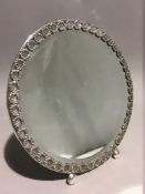 A Continental silver mirror of circular form.