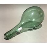 A hand blown green glass amphora bottle