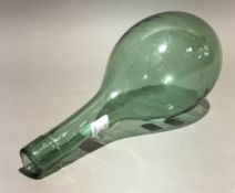 A hand blown green glass amphora bottle