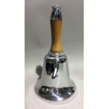 A vintage chrome and wood handled bell shaped cocktail shaker