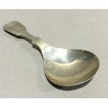 A silver caddy spoon
