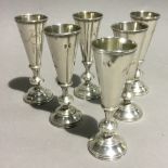 Six Russian silver vodka cups each engraved with bird and leaf decoration, 84 mark, maker H.3.