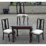 An early 20th century oak drawer leaf dining table and three chairs