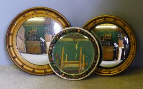 Two gilt framed convex wall glasses and another wall glass